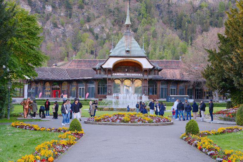 Example stock photograph of a historic casino building and flower garden in a mountain town