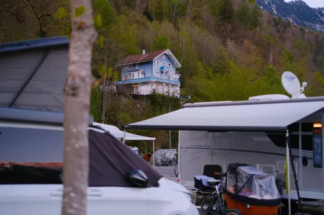 Turquoise alpine lake with paddle boats in late light